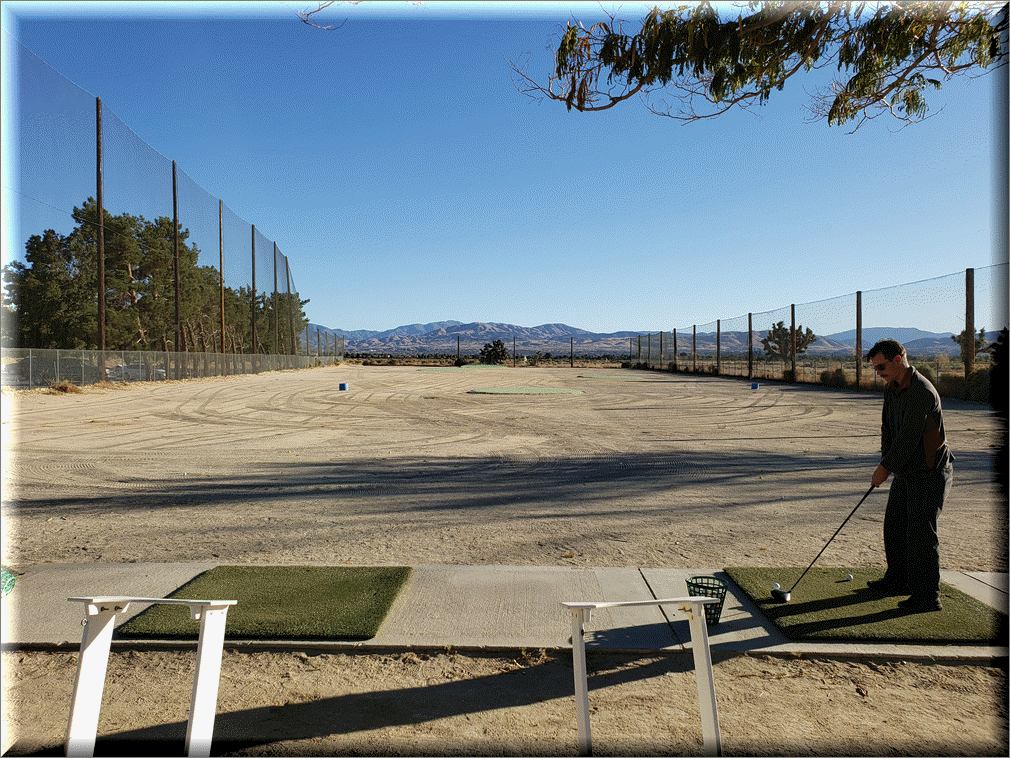 Golfer practicing at the driving range 